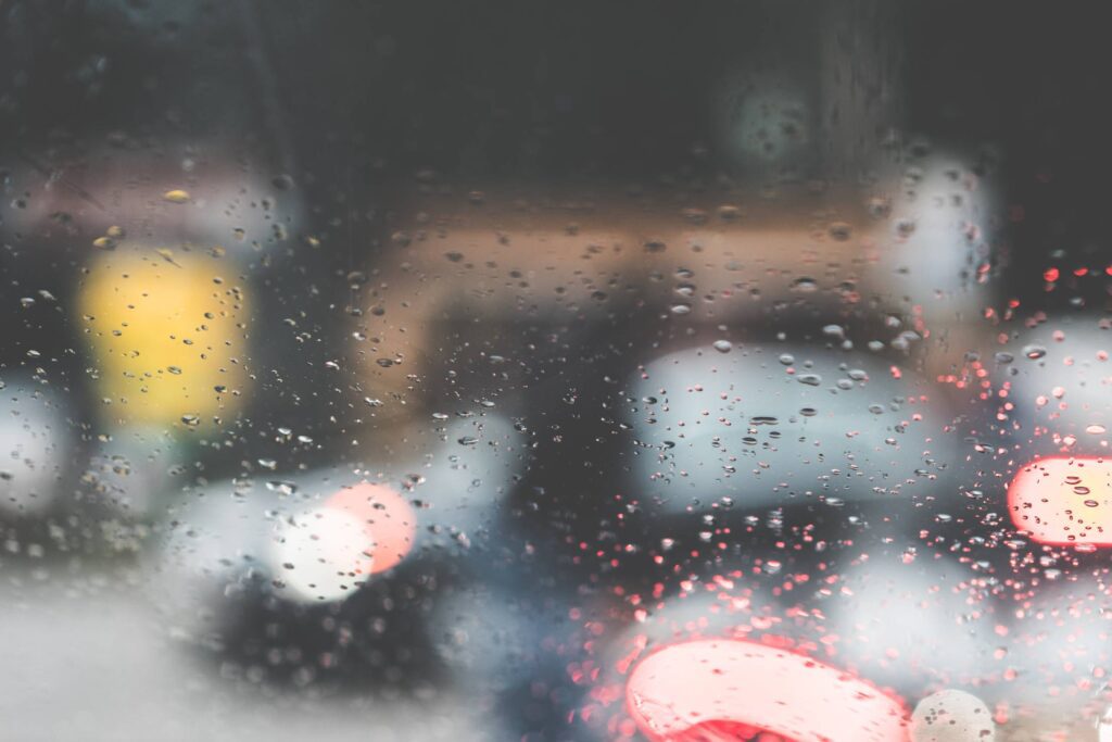 Rain Drops on a Car Windshield in a Rainy Day Free Photo