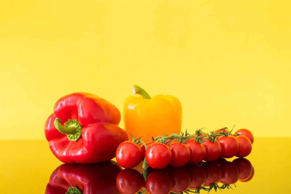 Red and Yellow Paprikas with Tomatoes Still Life Free Photo