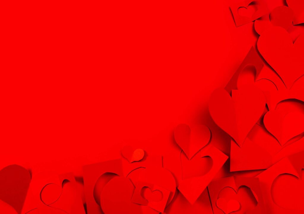 Red Background with Paper Hearts and Copy Space Free Photo