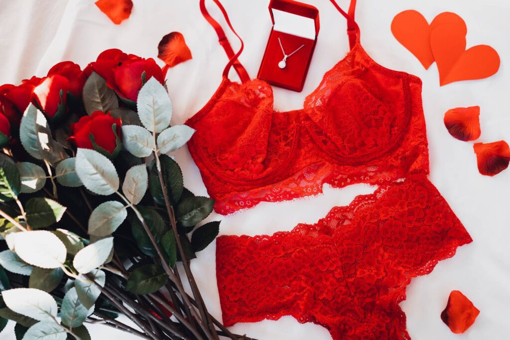 Red Sexy Lingerie with a Bouquet of Roses and a Necklace Free Photo