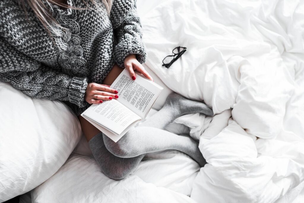 Relaxed Woman Reading in Bed Free Photo