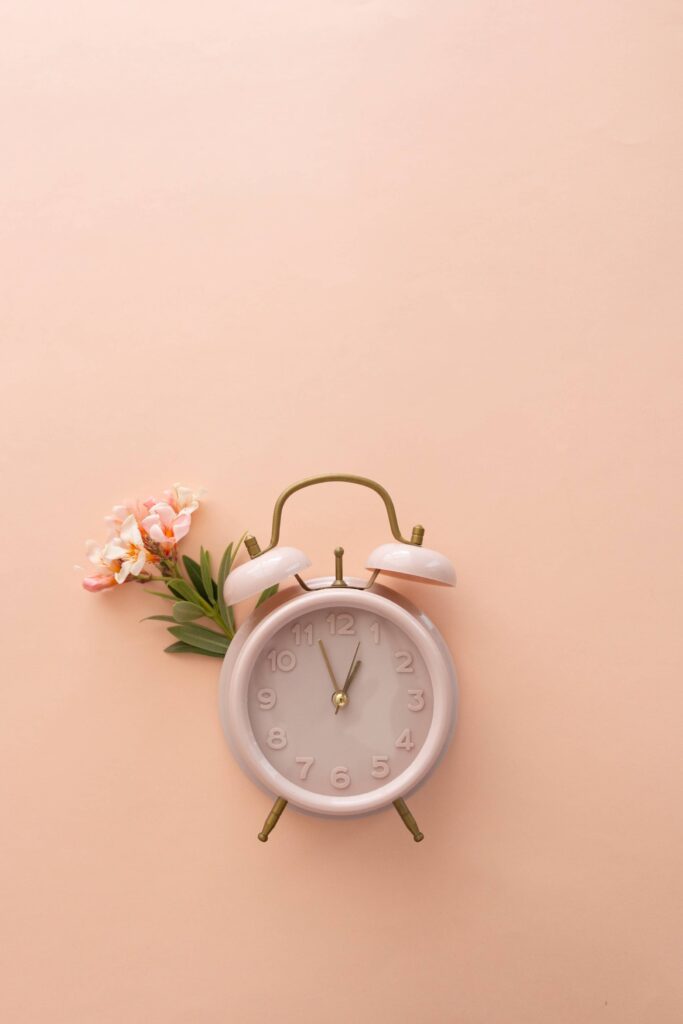 Retro Clock with Flower on Pastel Background Free Photo