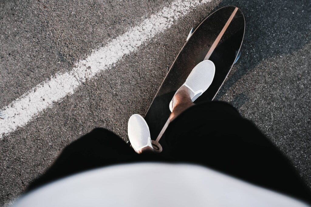 Riding a Longboard with Slip Ons Free Photo