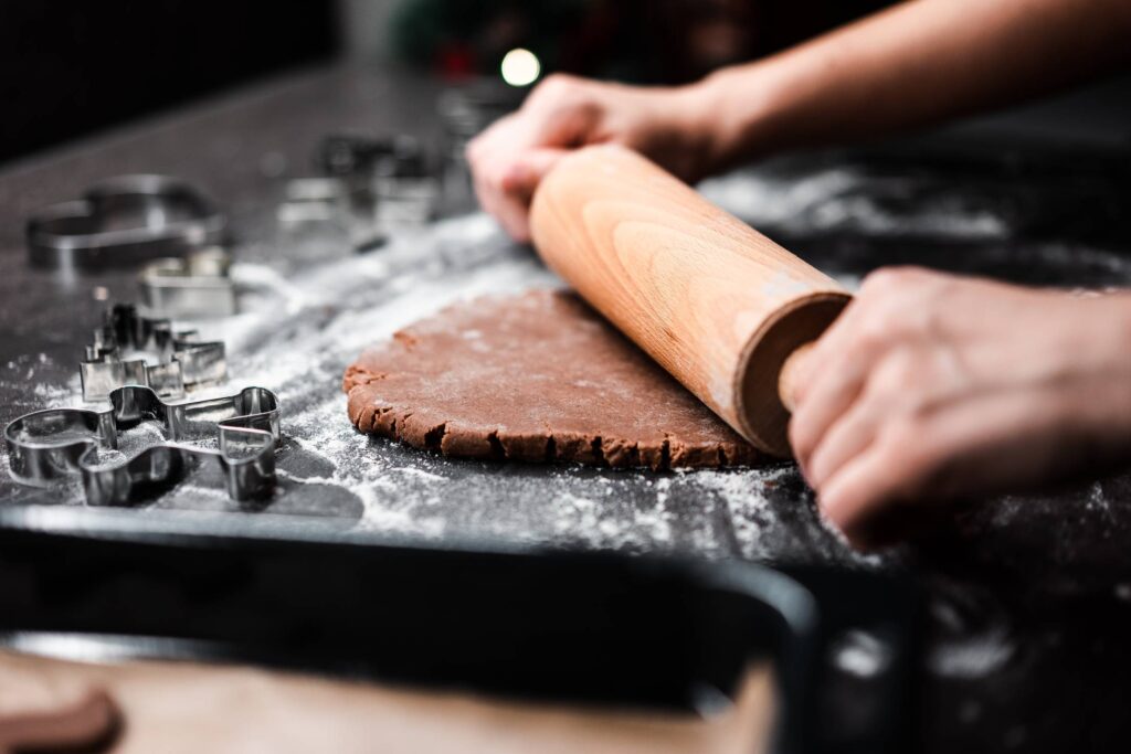 Rolling Homemade Gingerbread Dough for Christmas Biscuits Free Photo