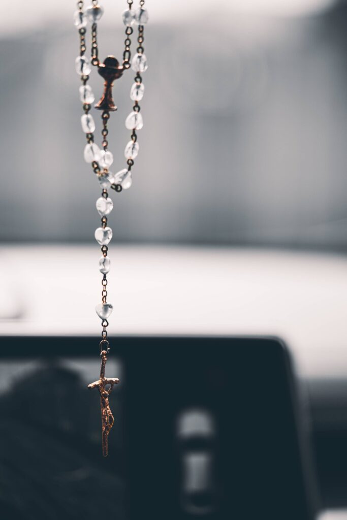 Rosary Christian Cross Hanging on the Mirror in the Car Free Photo