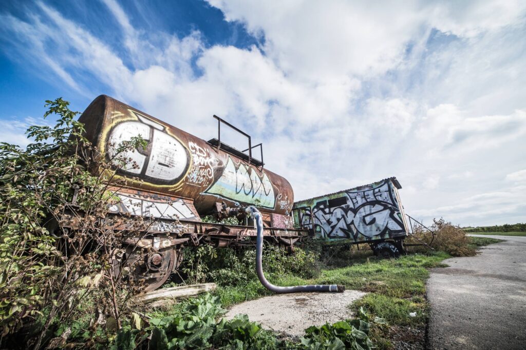 Rusted Wagon with Graffiti Art Alone in The Field Free Photo