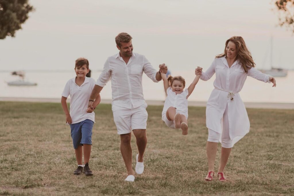 Senior couple in casual clothes with their children, boy and girl enjoy the beach spending a vacation together. Family time . Selective focus Stock Free