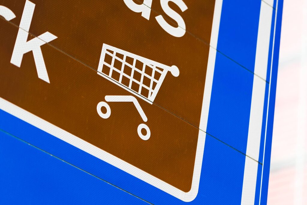 Shopping Cart Icon on Road Sign Free Photo