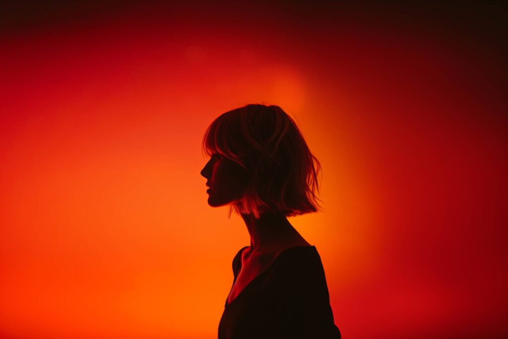 Silhouette of Young Blonde With Short Hair on Orange Background Stock Free