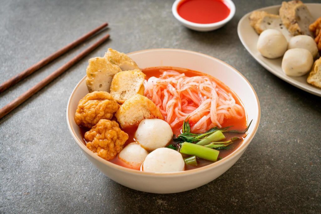 Small flat rice noodles with fish balls and shrimp balls in pink soup, Yen Ta Four or Yen Ta Fo – Asian food style Stock Free