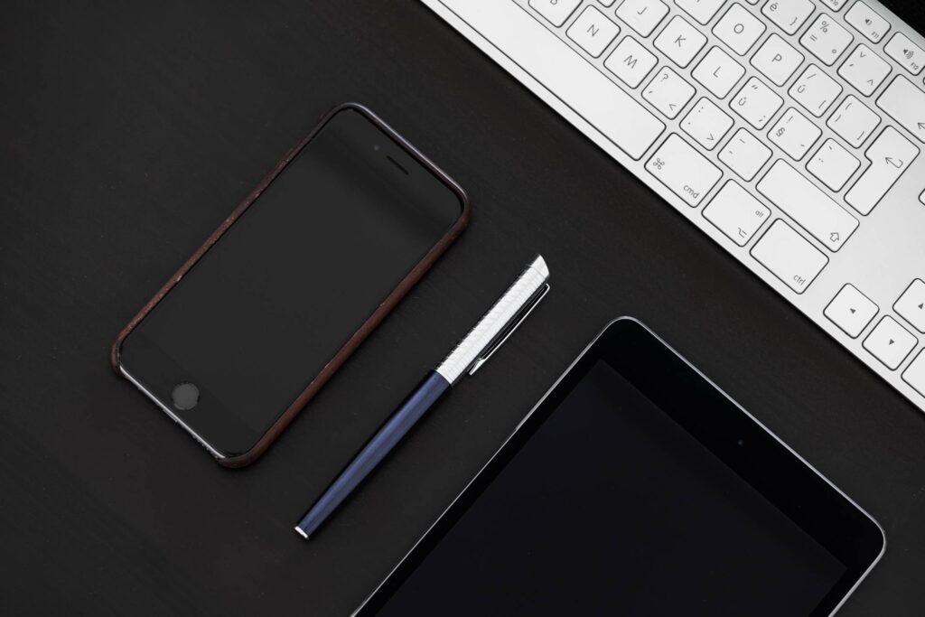 Smartphone with Pen on Office Desk From Above Free Photo