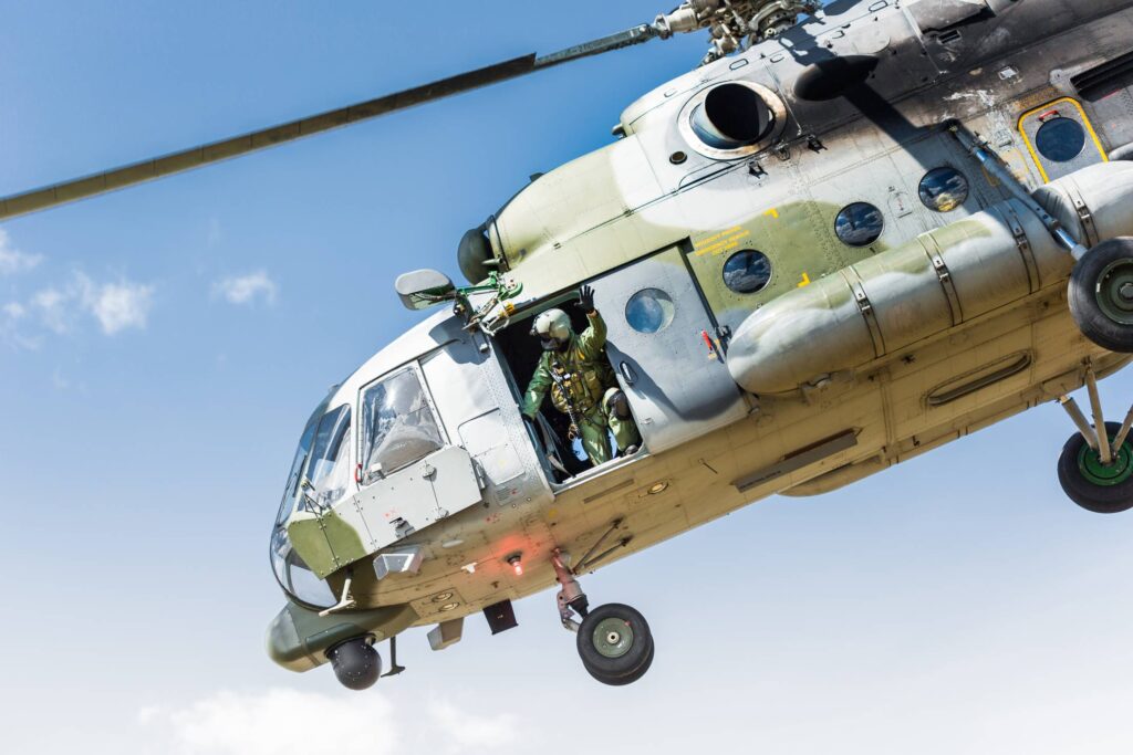 Soldier Waving from Army Helicopter Free Photo