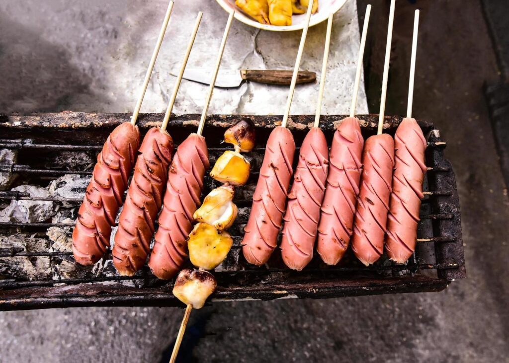 Squid and sausages burning at street food, Thailand Stock Free