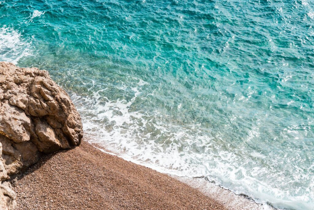 Stone Beach and Blue Sea Free Photo