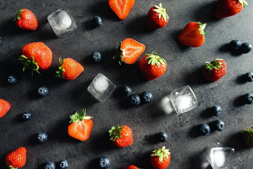 Strawberries and Blueberries Flat Lay on a Dark Background Free Photo