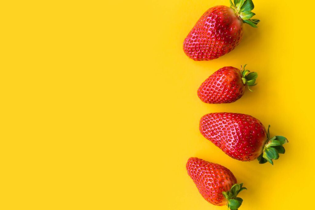 Strawberries with Yellow Background Free Photo