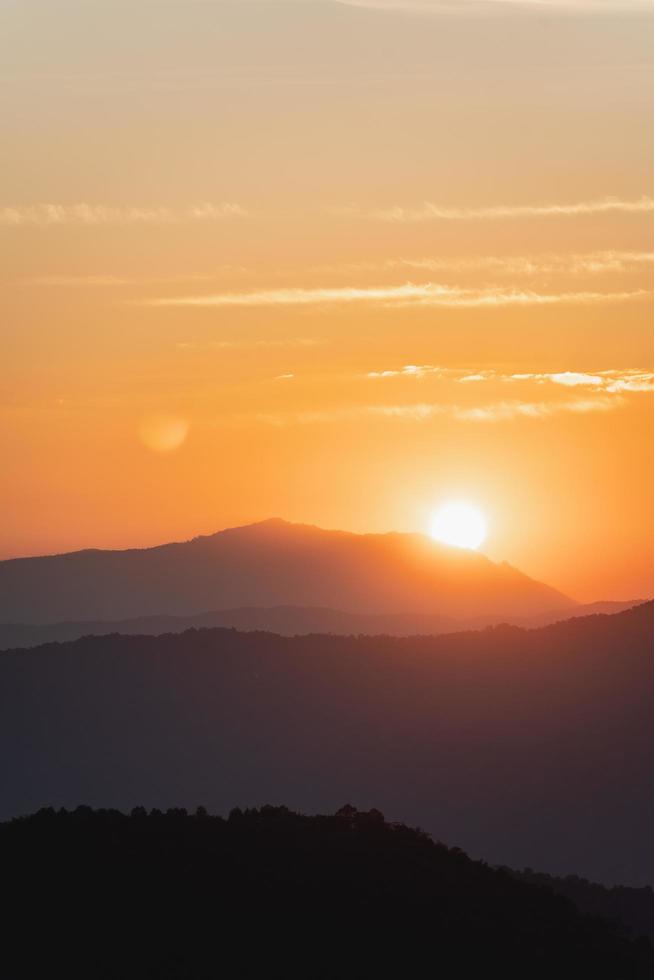 
									Sunset landscape with mountain and sun gold lighting under vibrant colorful evening sky in mountains. Nature mountain sky and clouds sunset concept Stock Free