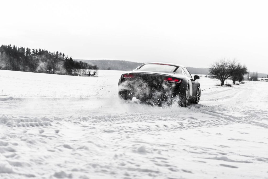 Supercar Drifting on a Snow Covered Road Free Photo