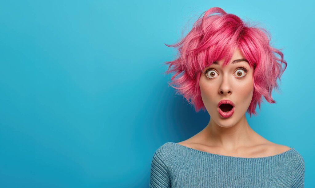 Surprised Woman With Pink Hair With Blue Background Space for Text Stock Free