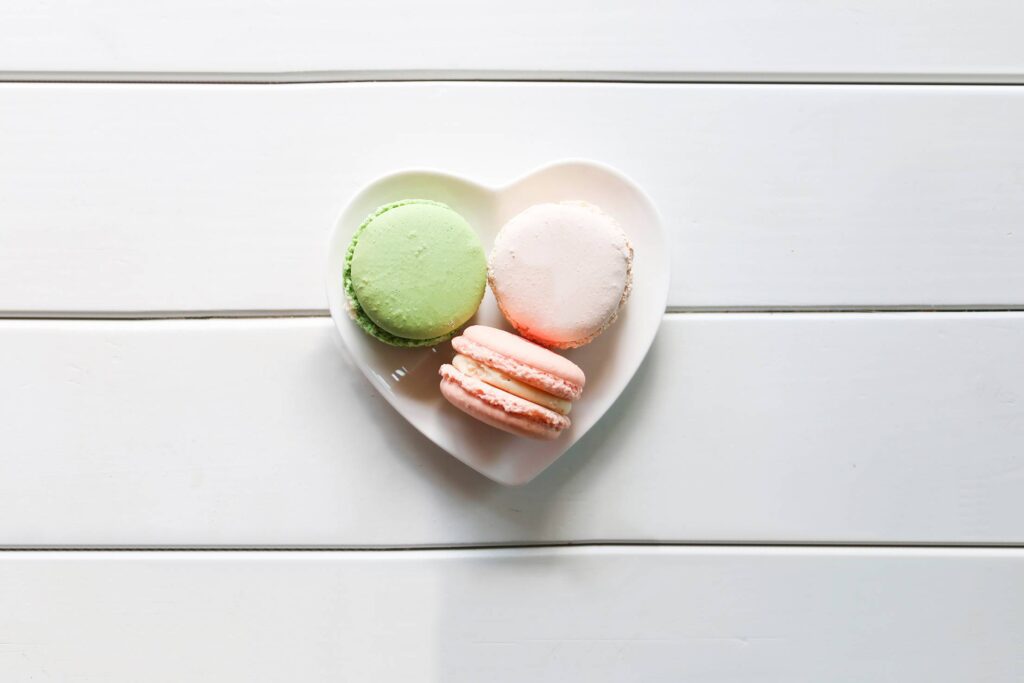 Sweet Macarons on a Heart-Shaped Plate Free Photo