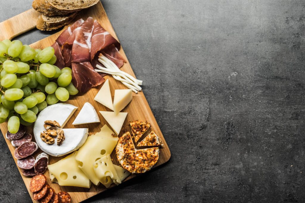 Tasting Cheese Dish on a Wooden Plate Free Photo