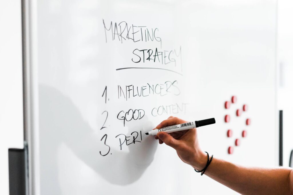 Team Leader Writing on White Board Free Photo