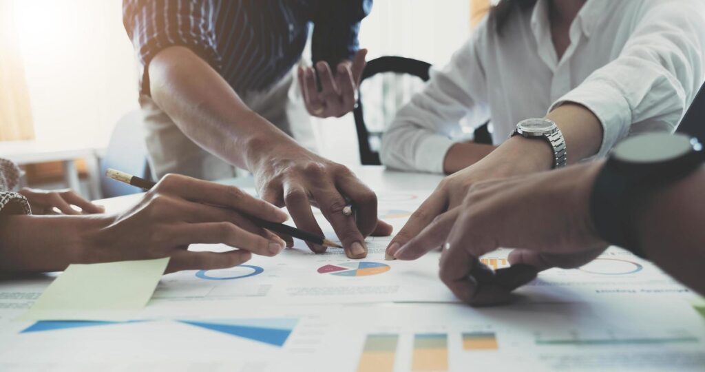 Team of business people working together in the meeting room office, teamwork background charts and graphs banner, double exposure successful teamwork,business planning concept. Free Photo