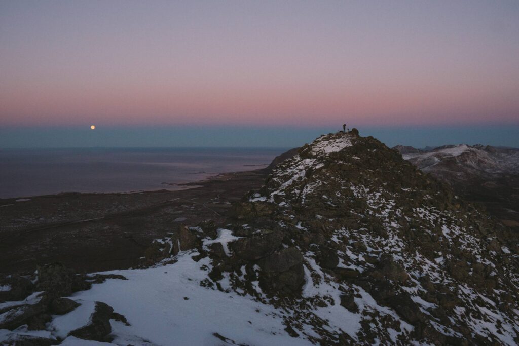 Tiny Person Taking a Photo from Mountain Peak Free Photo