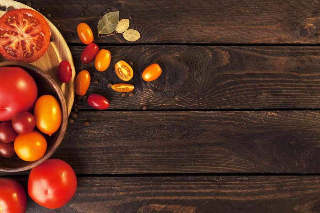 Tomatoes on wooden table background, top view Stock Free