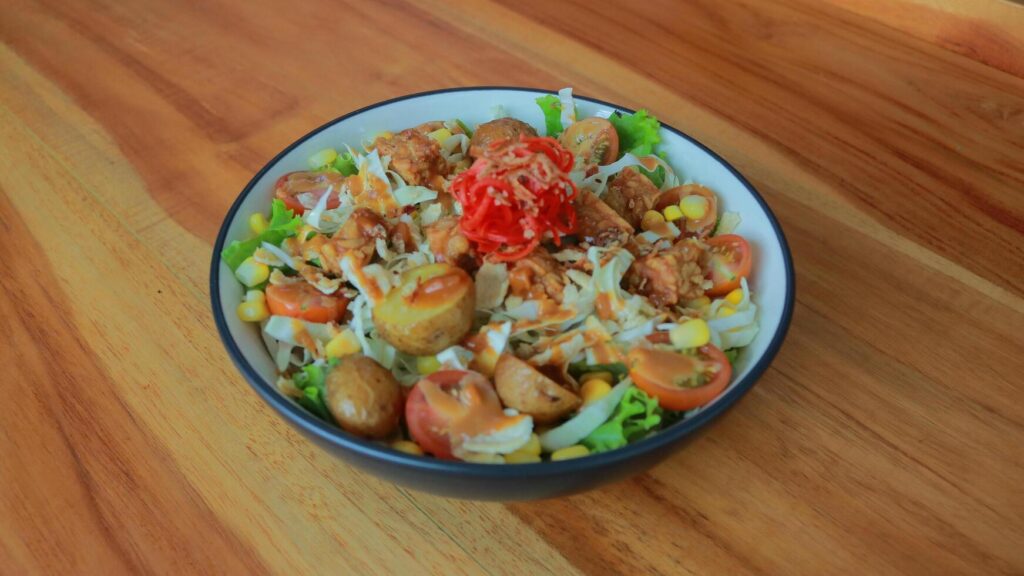 Top view of a bowl of gado-gado sprinkled with peanut sauce, suitable for seasoning satay, ketoprak, and others Stock Free