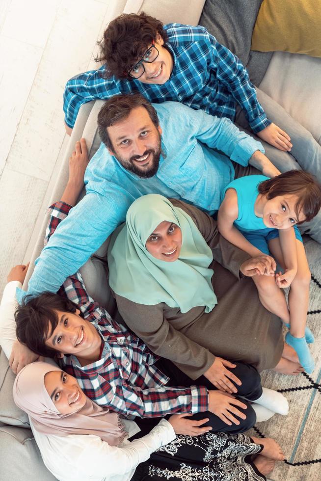 Top view photo of an Arab family sitting in the living room of a large modern house.Selective focus Stock Free