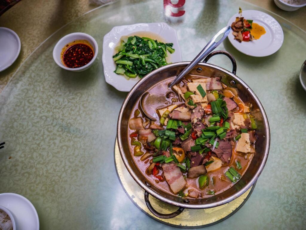 Top view of Larouguo or Spicy Smoked pork hotpot in chinese restaurant.Smoked pork famouse food in fenghuang old town hunan china Stock Free