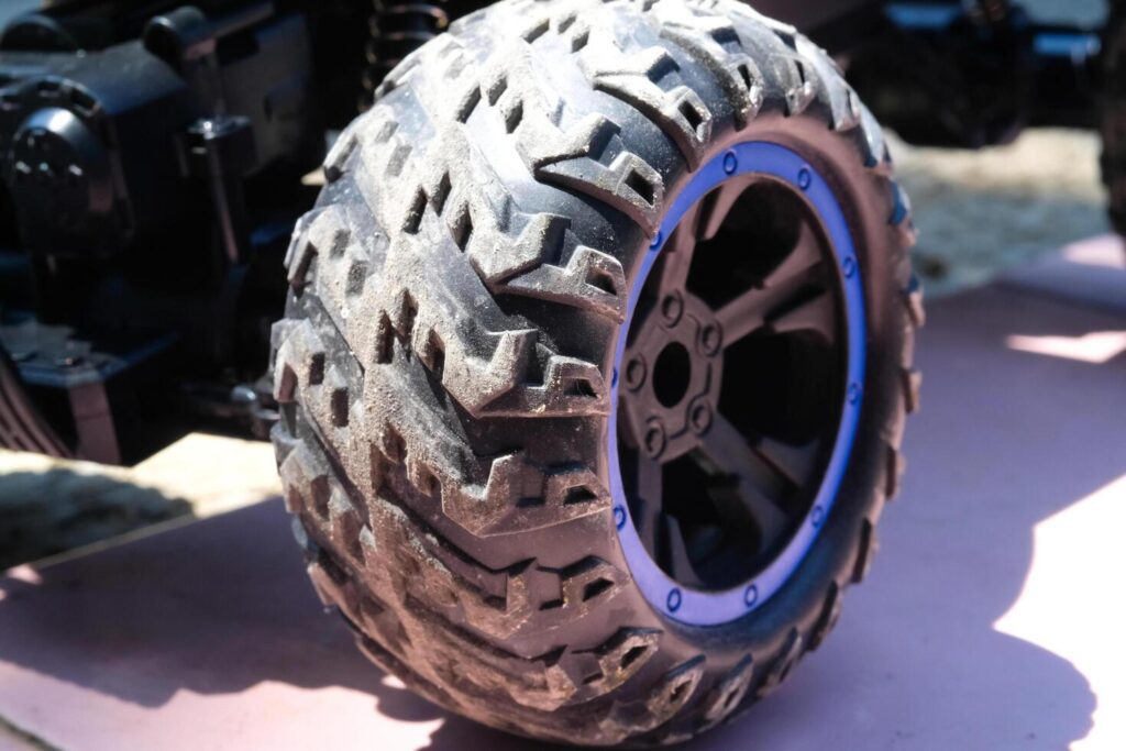 Toys Photography. Closeup Toys. Macrophotography of RC Remote Control Car tires. Closeup shot of tire groove texture with blue rims. Shot with a macro lens Stock Free