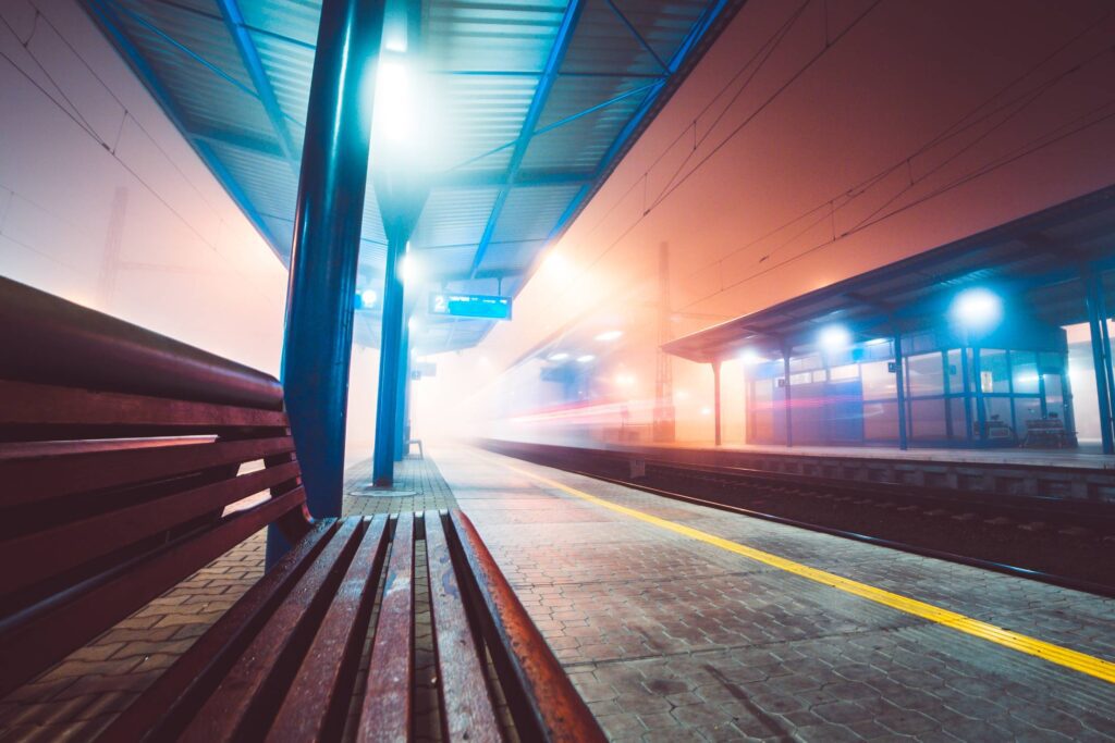 Train Leaving Railway Station in Foggy Night Free Photo