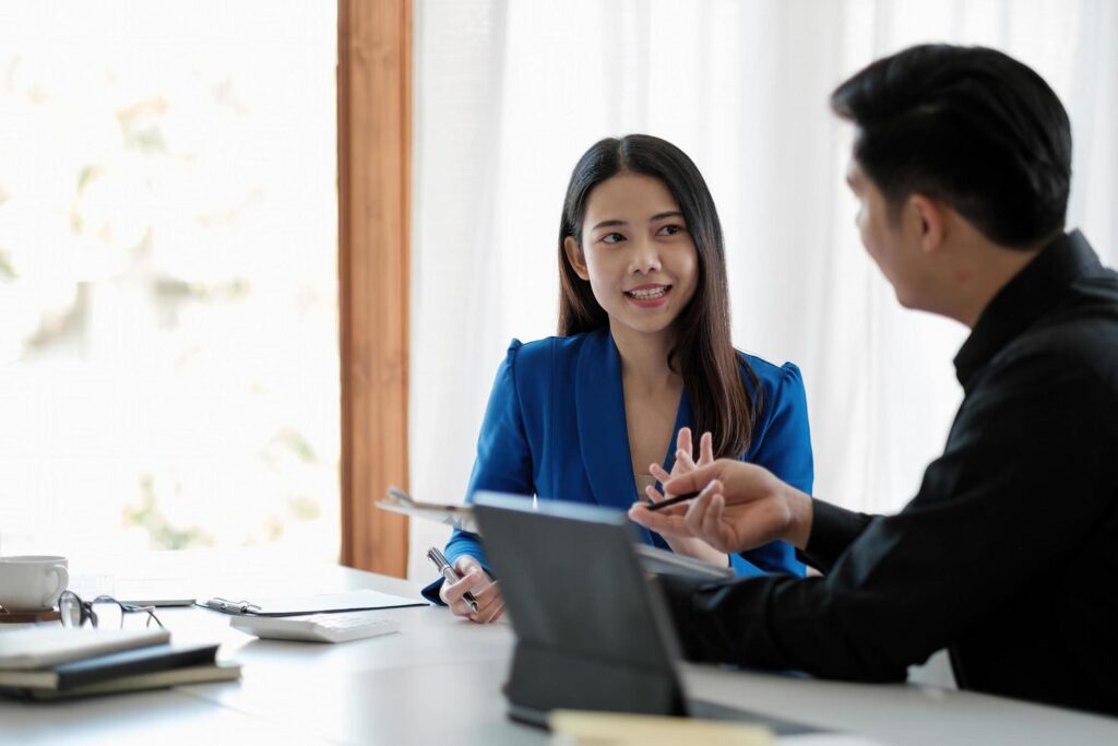 Two colleagues discussing data with document data on desk table. Close up business people meeting to discuss the situation on the market. Stock Free