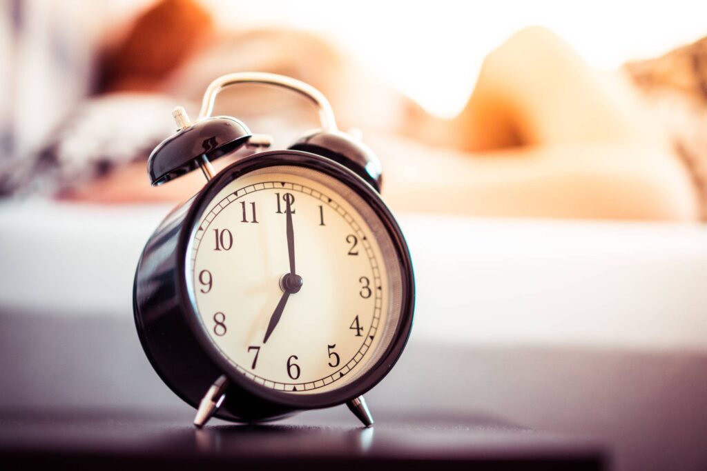 Vintage Alarm Clock and Sleeping Woman Free Photo