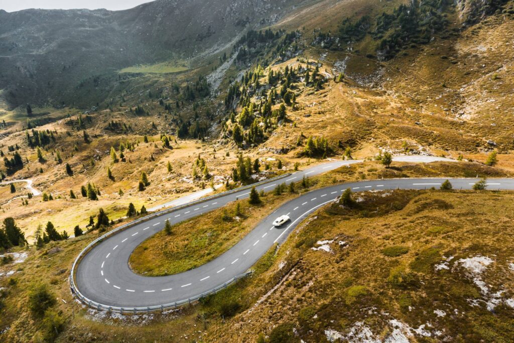 Vintage Car Running On a Fantastic Road in Pure Nature Free Photo