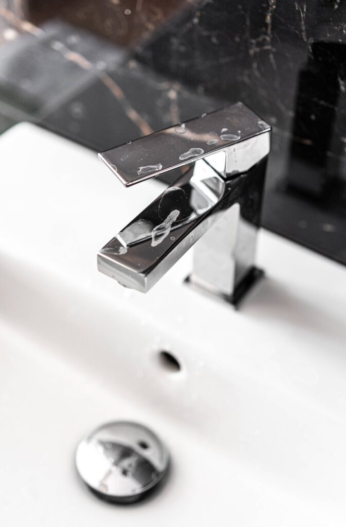 Water Scale on a Modern Faucet in Bathroom Free Photo