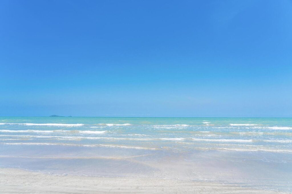 Wave on the sea and blue sky on summer beach for background Stock Free