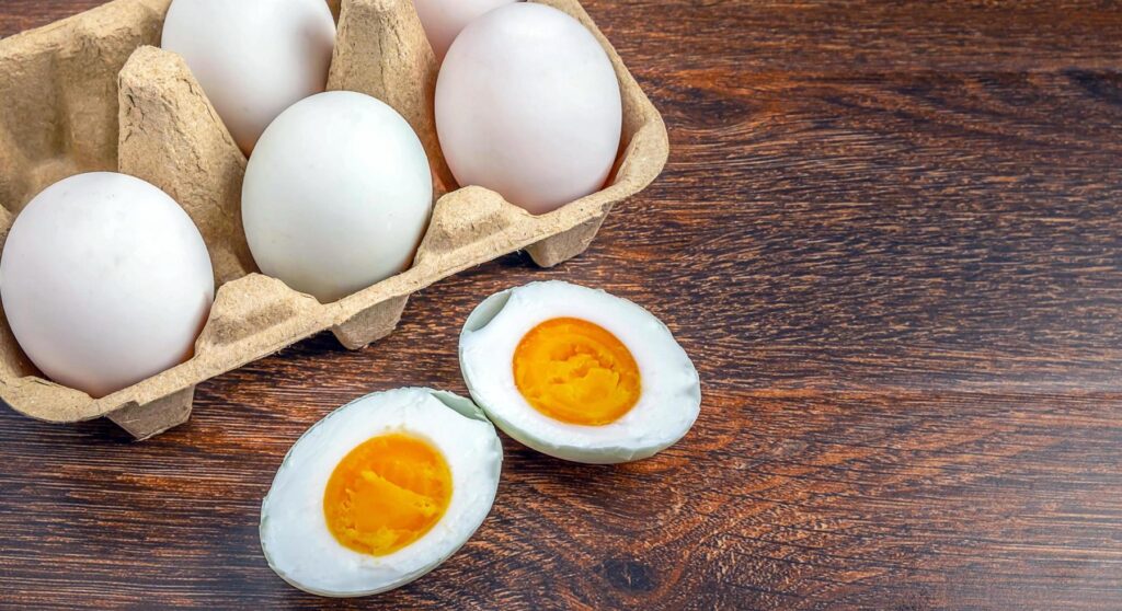 White duck eggs and salted egg food on a wooden table Stock Free