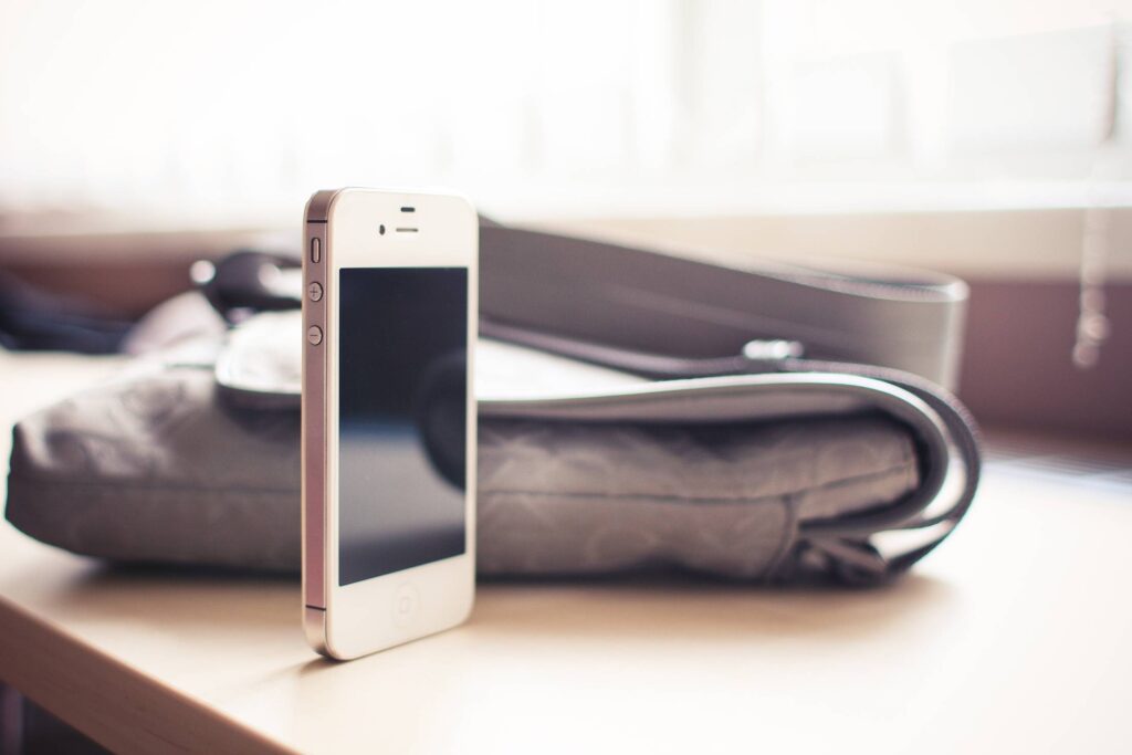 White iPhone 4S standing on the Desk Free Photo