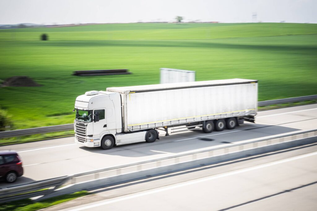 White TIR Truck in Motion Driving on Highway Free Photo