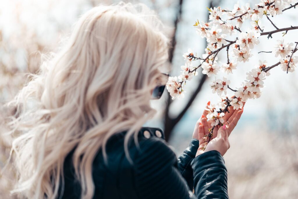 Woman Admiring Beautiful Almond Blossoms Free Photo