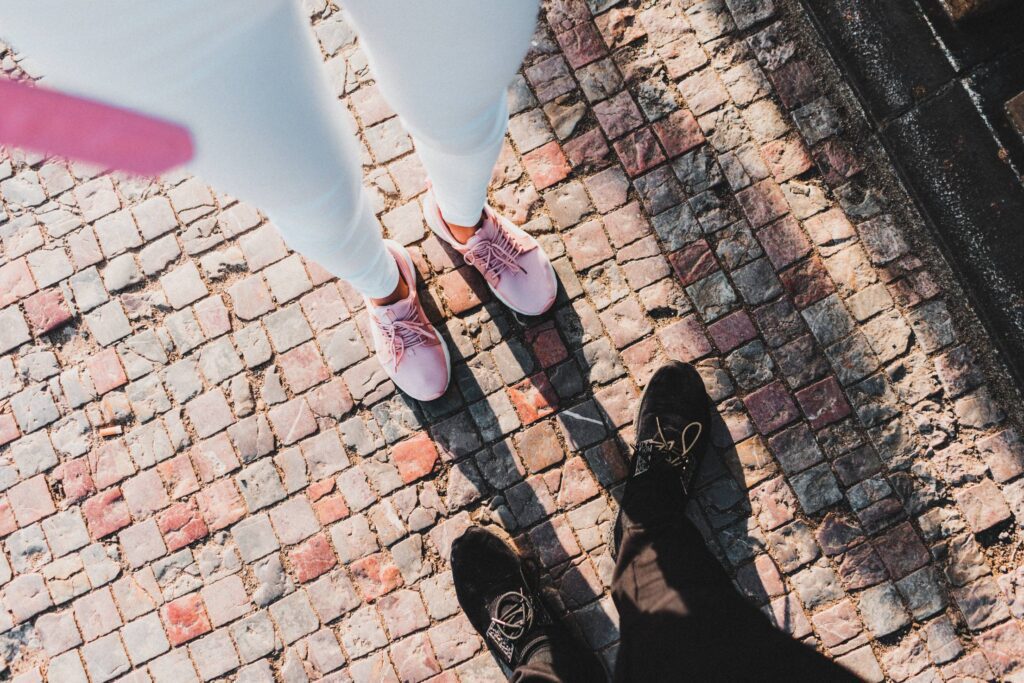 Woman and Man Standing on an Old Historic Sidewalk Free Photo