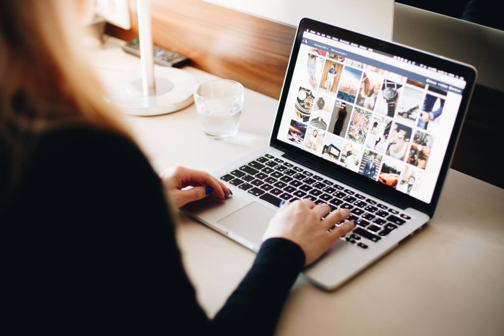 Woman Browsing Tumblr on Her Laptop Free Photo