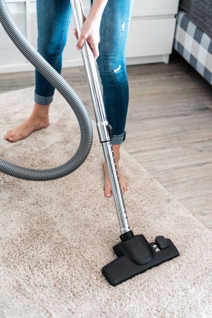 Woman Cleaning Vacuuming the Carpet at Home Free Photo