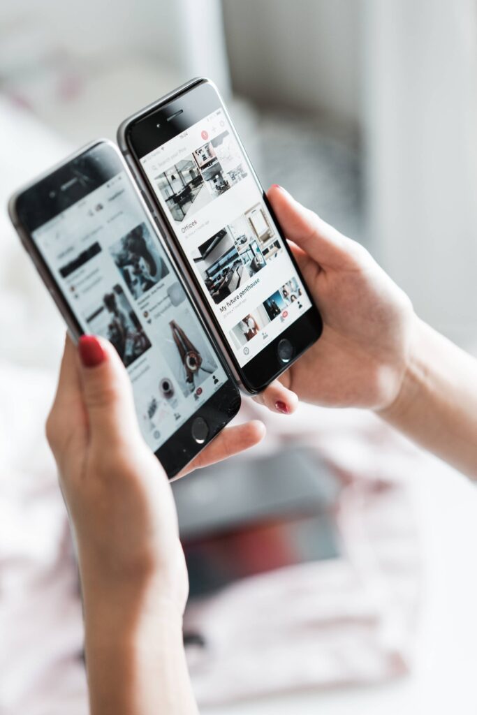 Woman Comparing Two Older iPhones Free Photo