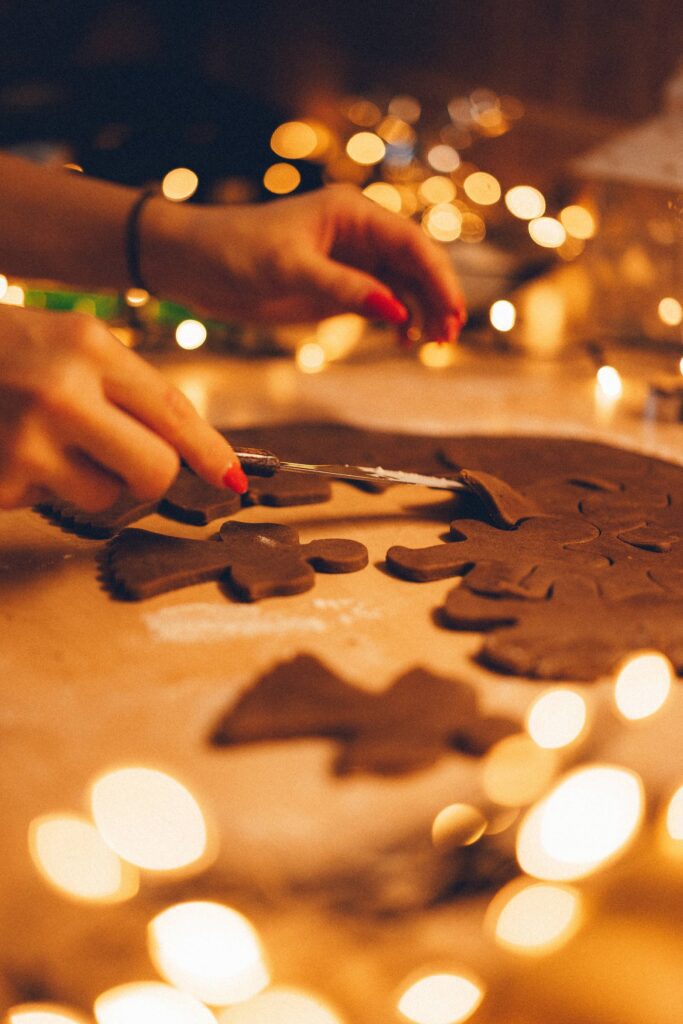 Woman Cutting Gingerbread Cookies Free Photo