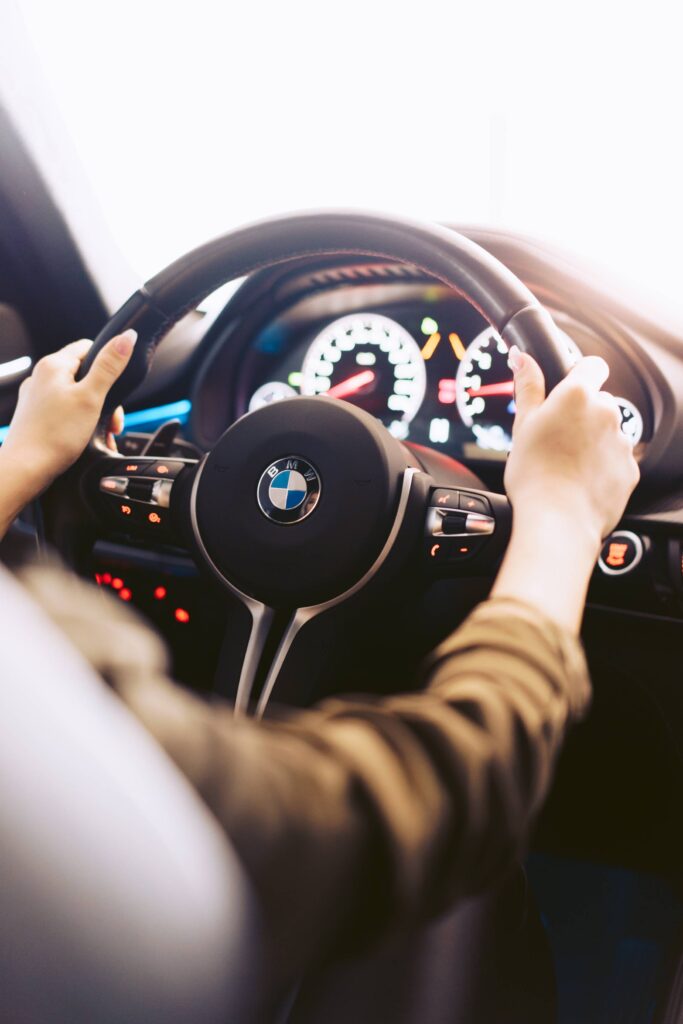 Woman Driving a Luxury Car Vertical Free Photo