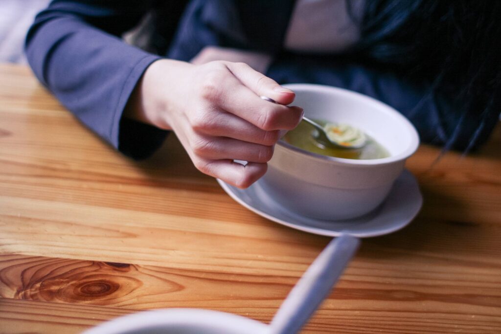 Woman Eating a Soup Free Photo